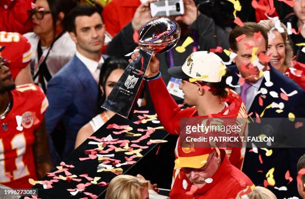 Kansas City Chiefs' quarterback Patrick Mahomes holds the trophy after winning Super Bowl LVIII against the San Francisco 49ers at Allegiant Stadium...