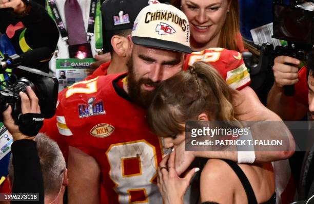 Singer-songwriter Taylor Swift and Kansas City Chiefs' tight end Travis Kelce embrace after the Chiefs won Super Bowl LVIII against the San Francisco...