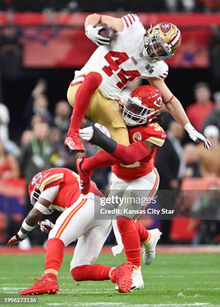 San Francisco 49ers fullback Kyle Juszczyk tries to leap over Kansas City Chiefs linebacker Nick Bolton in the first quarter of Super Bowl LVIII,...