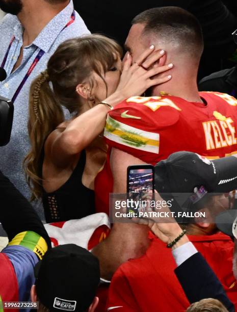 Singer-songwriter Taylor Swift kisses Kansas City Chiefs' tight end Travis Kelce after the Chiefs won Super Bowl LVIII against the San Francisco...