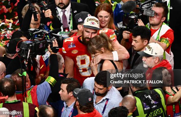 Singer-songwriter Taylor Swift and Kansas City Chiefs' tight end Travis Kelce embrace after the Chiefs won Super Bowl LVIII against the San Francisco...