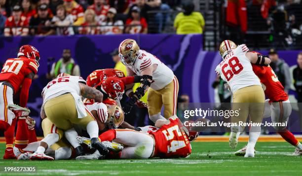 San Francisco 49ers running back Christian McCaffrey, obscured, fumbles the ball during the first half of Super Bowl LVIII at Allegiant Stadium on...