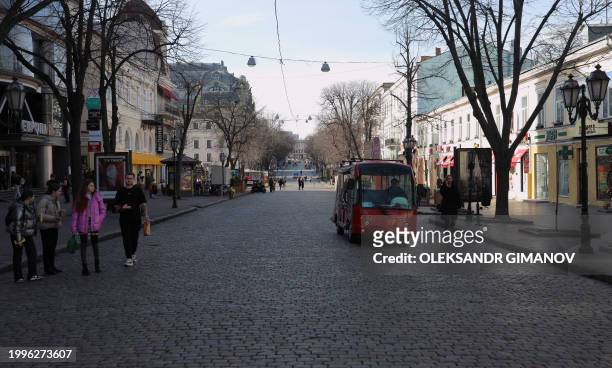 People walk on a street in the southern city of Odesa, on February 9 amid the Russian invasion of Ukraine.