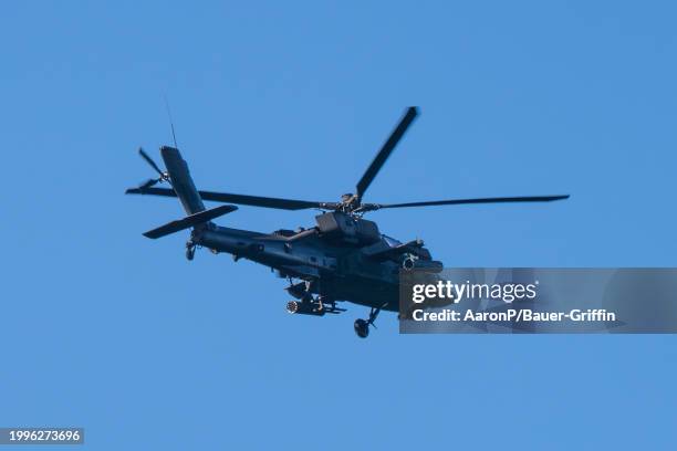 General view of an Apache helicopter flying over the Los Angeles South Bay area on February 11, 2024 in Los Angeles, California.