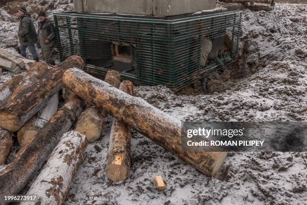 Men work on the construction of fortification and a trench system on the Kupiansk direction, in the Kharkiv region, on January 29 amid the Russian...