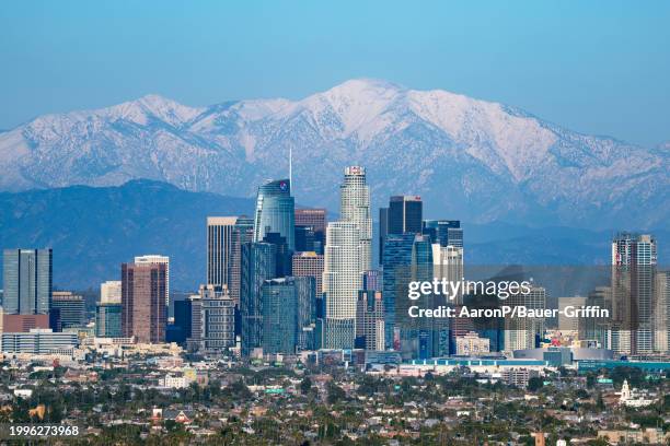 General views of the downtown Los Angeles skyline against the snowy San Gabriel Mountains after a recent winter storm system passes on February 11,...