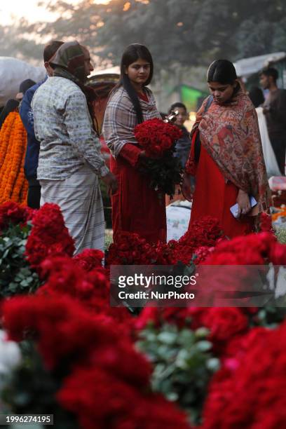 Women are purchasing flowers at a wholesale flower market in Dhaka, Bangladesh, on February 12 ahead of Valentine's Day.