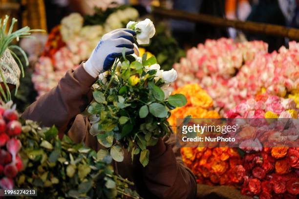 Vendor is arranging flowers at a wholesale flower market ahead of Valentine's Day in Dhaka, Bangladesh, on February 12, 2024.