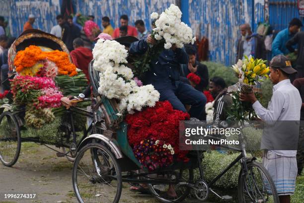 Man is loading flowers onto a rickshaw at a wholesale flower market ahead of Valentine's Day in Dhaka, Bangladesh, on February 12, 2024.