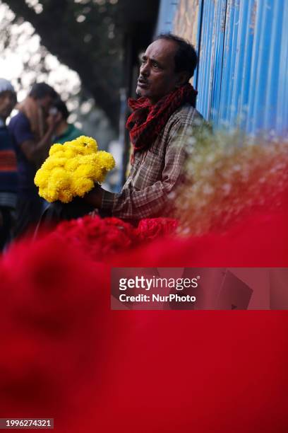 Vendor is waiting for customers at a wholesale flower market ahead of Valentine's Day in Dhaka, Bangladesh, on February 12, 2024.