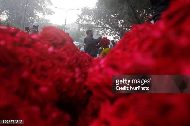 Vendor is arranging flowers at a wholesale flower market ahead of Valentine's Day in Dhaka, Bangladesh, on February 12, 2024.