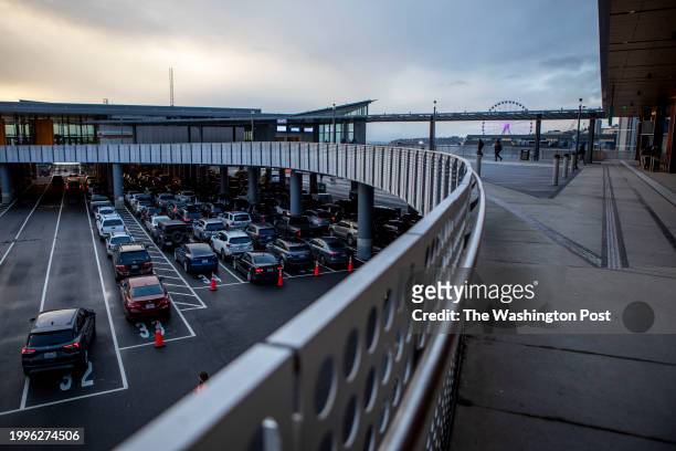 Cars line up and people gather for the next Bainbridge Island ferry at the Seattle Ferry Terminal in Seattle, Washington on Thursday, Jan. 25, 2024....