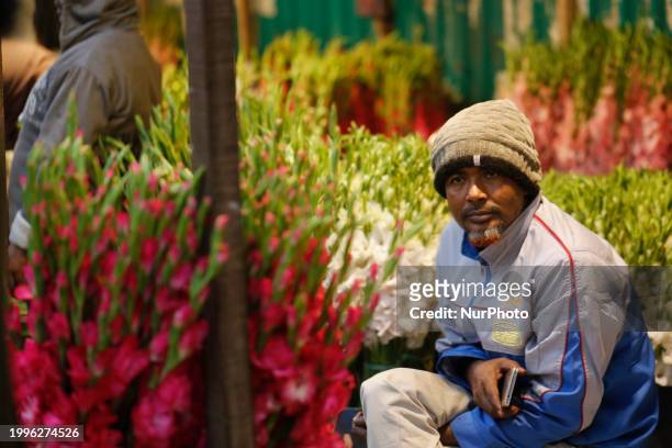 Vendor is waiting for customers at a wholesale flower market ahead of Valentine's Day in Dhaka, Bangladesh, on February 12, 2024.