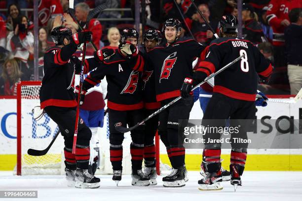 Martin Necas of the Carolina Hurricanes celebrates with his team following his hat trick goal during the first period of the game against the...