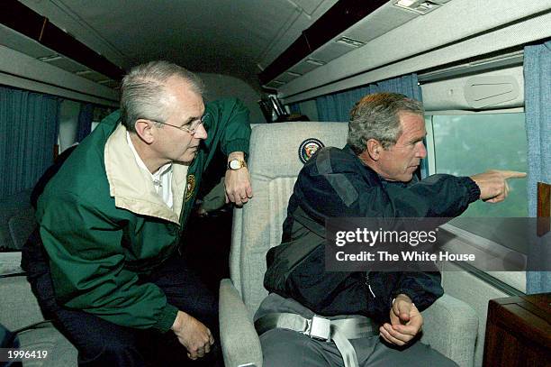 President George W. Bush and Missouri Governor Bob Holden survey tornado damage stretching between Springfield and Pierce City, Missouri May 13, 2003...