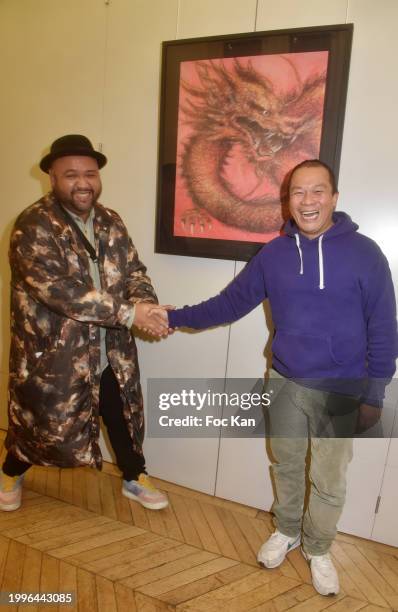 Presenter Raphal Yem and painter Hom Nguyen attends the Hom Nguyen’s preview of the "Peace" exhibition at Mairie du 13eme on February 08, 2024 in...