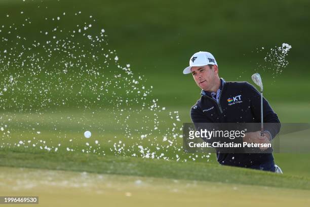 Luke List of the United States plays a shot from a bunker on the ninth hole during the first round of the WM Phoenix Open at TPC Scottsdale on...