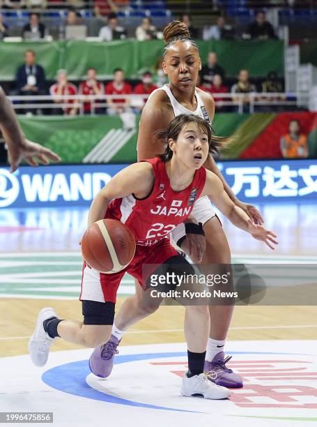 Japan's Mai Yamamoto dribbles the ball during the first quarter of an Olympic women's basketball qualifier against Canada on Feb. 11 in Sopron,...