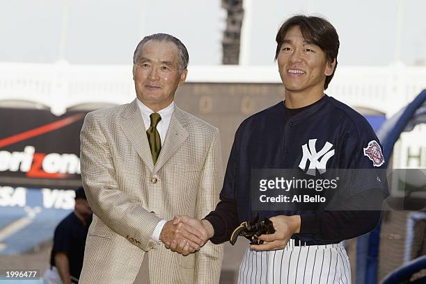 Hideki Matsui of the New York Yankees poses with former manager Shigeo Nagashima of the Yomiyuri Giants before the game against the Seattle Mariners...