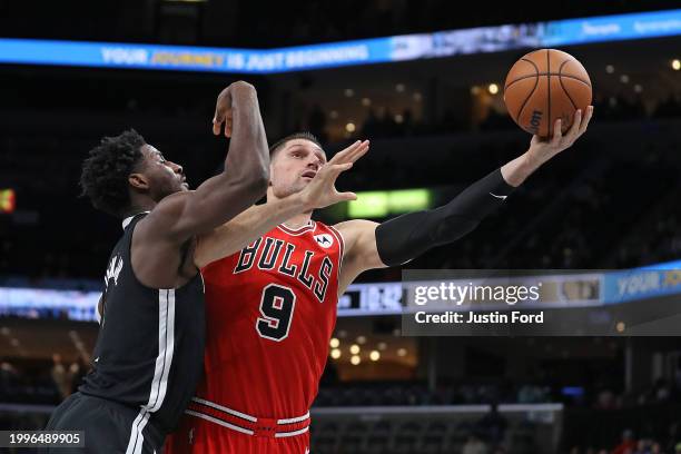 Nikola Vucevic of the Chicago Bulls goes to the basket against Jaren Jackson Jr. #13 of the Memphis Grizzlies during the first half at FedExForum on...