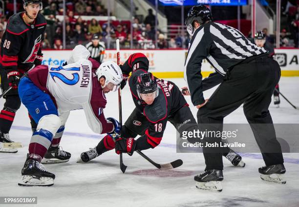 Jack Drury of the Carolina Hurricanes faces off against Ryan Johansen of the Colorado Avalanche during the second period at PNC Arena on February 08,...
