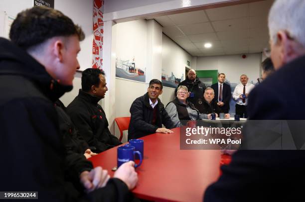 British Prime Minister Rishi Sunak meets with bus drivers as he visits a bus depot on February 12, 2024 in Harrogate, England.
