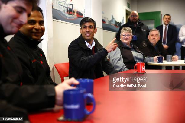 British Prime Minister Rishi Sunak meets with bus drivers as he visits a bus depot on February 12, 2024 in Harrogate, England.