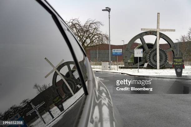 Mock gravestone reading "Our future Rests Here. R.I.P" and a cross at an entrance to the closed Vallourec SACA pipe plant in Düsseldorf, Germany, on...