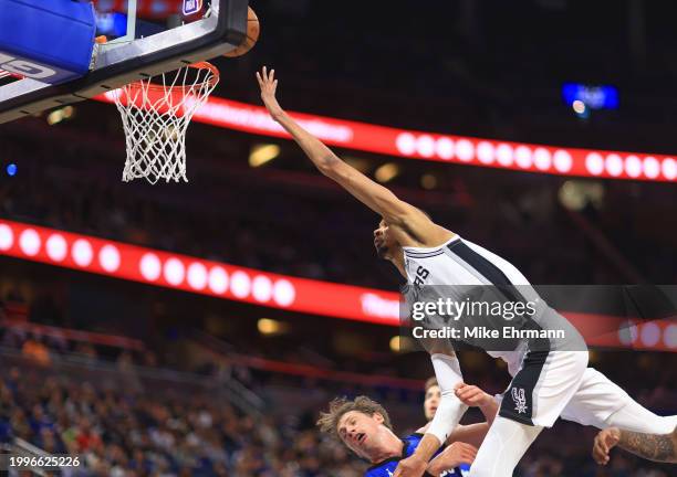 Victor Wembanyama of the San Antonio Spurs drives on Moritz Wagner of the Orlando Magic during a game at Kia Center on February 08, 2024 in Orlando,...
