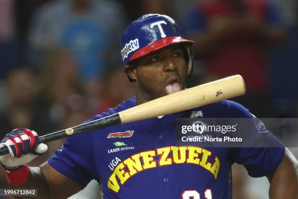 Yasiel Puig of Tiburones de La Guaira of Venezuela licks a bat in the third inning of the semi-final game between Venezuela and Curacao at loanDepot...