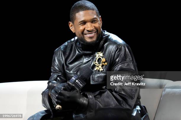 Usher speaks onstage during the Super Bowl LVIII Pregame & Apple Music Super Bowl LVIII Halftime Show Press Conference at the Mandalay Bay Convention...