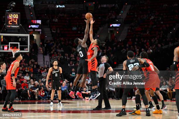 Jalen Duren of the Detroit Pistons and Jabari Walker of the Portland Trail Blazers fight for the opening tipoff at the Moda Center on February 08,...