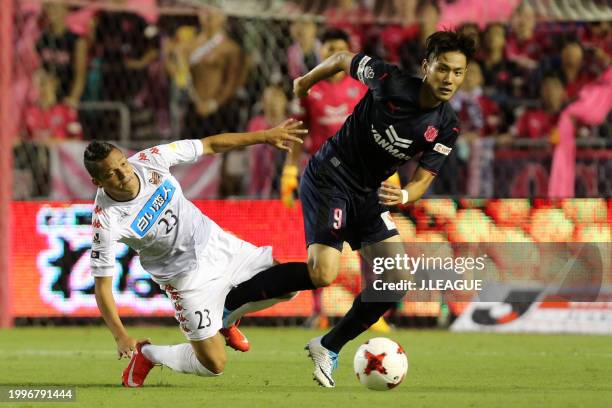 Kenyu Sugimoto of Cerezo Osaka controls the ball against Diego Macedo of Consadole Sapporo during the J.League J1 match between Cerezo Osaka and...