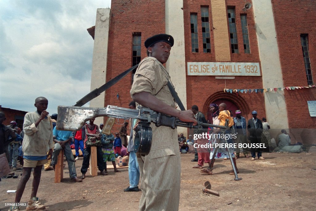 Tutsis In Rwanda A Rwandan soldier from the Tutsi minority stands in front of the Holy ...