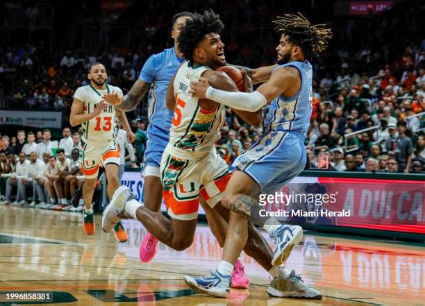 Miami Hurricanes forward Norchad Omier battles North Carolina Tar Heels guard RJ Davis in the paint in the first half at the Watsco Center in Coral...