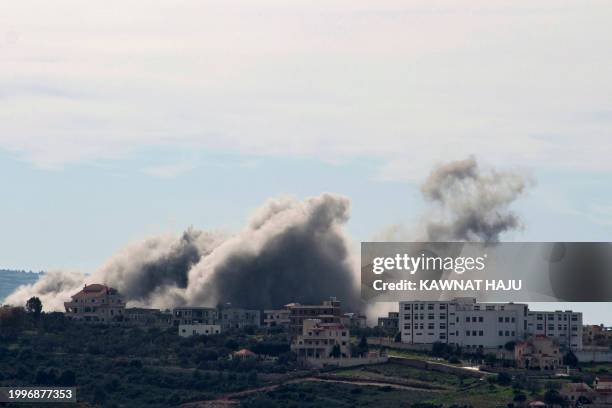 Smoke billows from the southern Lebanese village of Tayr Harfa near the boder with Israel following an Israeli airstrike, on February 12, 2024.