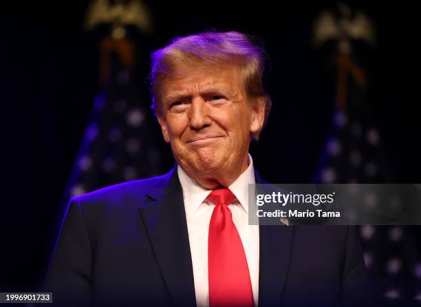 Republican presidential candidate and former U.S. President Donald Trump greets supporters during his caucus night watch party at the Treasure Island...