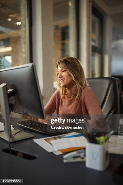 happy female programmer reading codes on pc in the office. - programmer working stock pictures, royalty-free photos & images