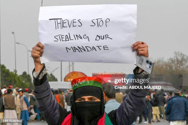 Supporters of Khan's Pakistan Tehreek-e-Insaf party block Peshawar to Islambad highway as they protest against the alleged skewing in Pakistan's...