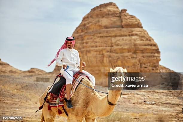 saudi man in traditional clothing on camel - mada'in saleh stockfoto's en -beelden