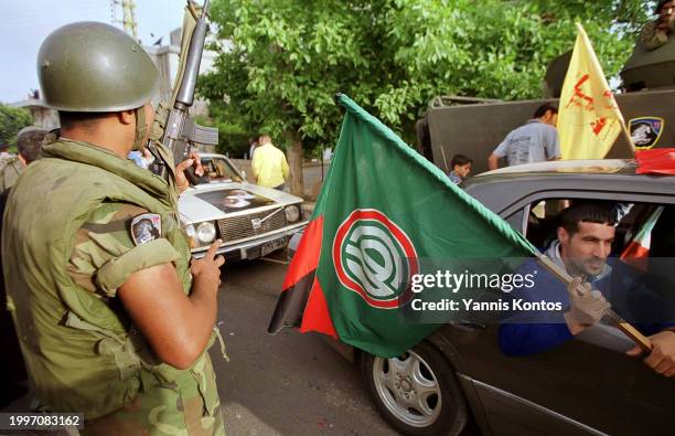 Lebanese Hezbollah and Amal movement supporters celebrate following the Israeli withdrawal from Southern Lebanon after nearly two decades, in Kfar...