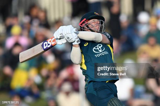 David Warner of Australia hits a boundary during game one of the Men's T20 International series between Australia and West Indies at Blundstone Arena...
