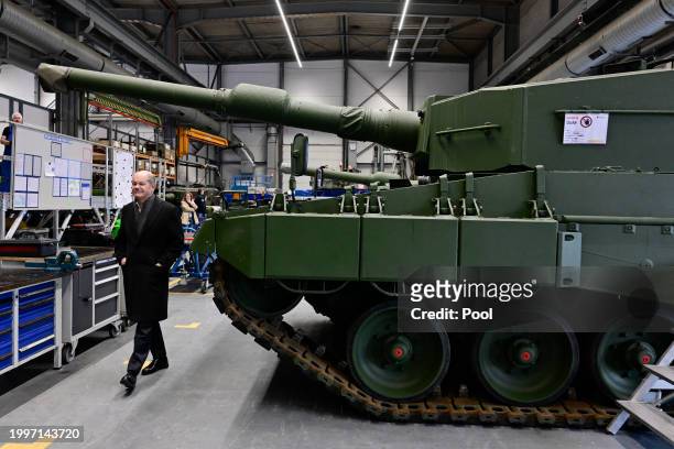 German Chancellor Olaf Scholz visits a production line as he and Defence Minister Boris Pistorius attend the groundbreaking ceremony for a new...