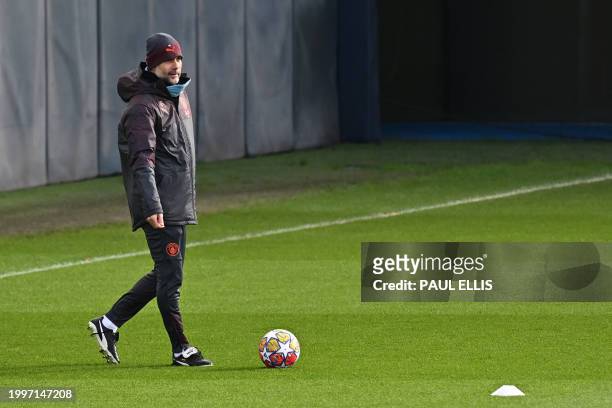 Manchester City's Spanish manager Pep Guardiola attends a training session at Manchester City's training ground in north-west England on February 12...