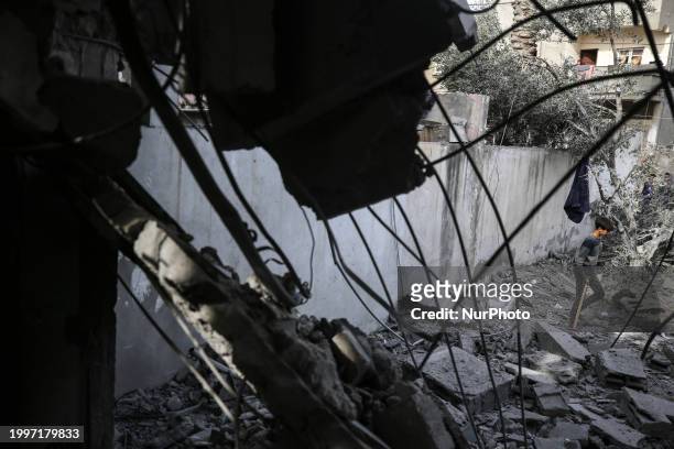 Palestinians are inspecting the damage caused by Israeli bombardment in Deir al-Balah, central Gaza Strip, on February 12 as battles are continuing...