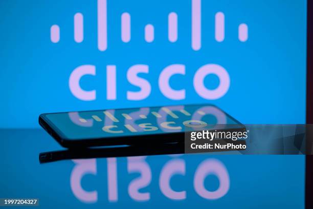 The Sisco logo is being displayed on a smartphone with Cisco visible in the background in this photo illustration in Brussels, Belgium, on February...