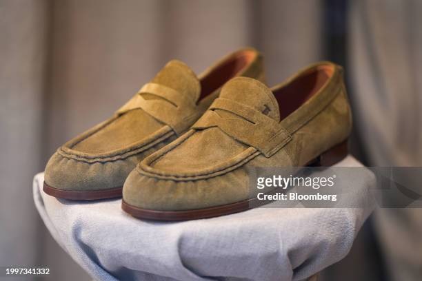 Pair of men's suede loafers in the window of a Tod's SpA luxury boutique in central Paris, France, on Monday, Feb. 12, 2024. The founding family...