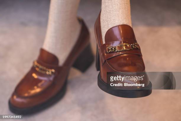Pair of women's leather loafers in the window of a Tod's SpA luxury boutique in central Paris, France, on Monday, Feb. 12, 2024. The founding family...