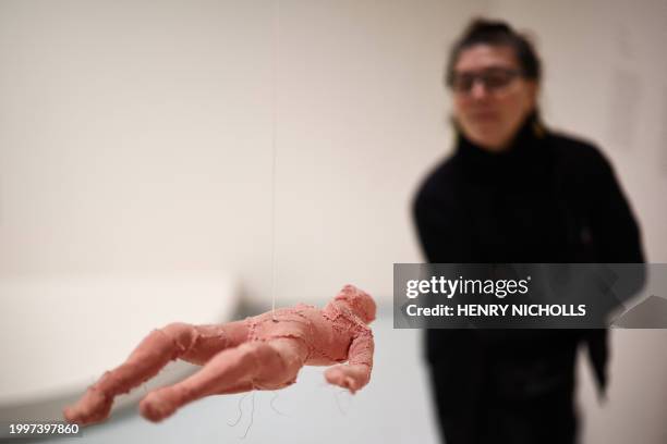 Visitor looks at a piece by Frent artist Louise Bourgeois called "Arch of Hysteria" during a press preview ahead of the exhibition 'Unravel: The...