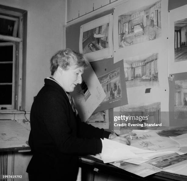 Art director and designer Carmen Dillon drawing in an art studio, December 22nd 1955.